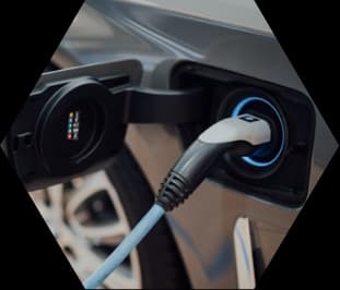 A charging cable plugged into an electric vehicle