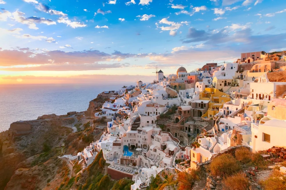 Santorini cliffside village overlooking the sea at sunset