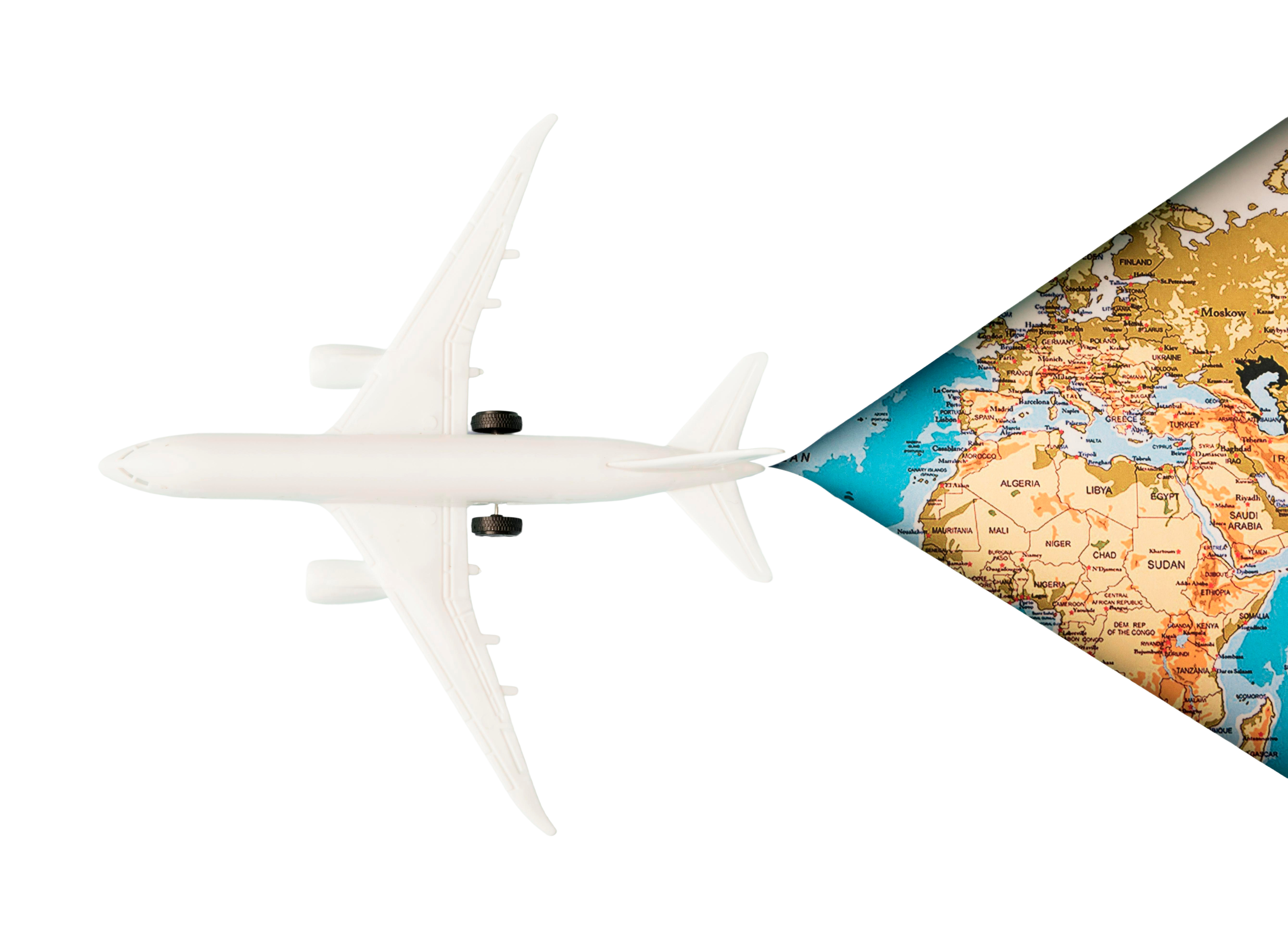 Top view of a white toy plane on a map